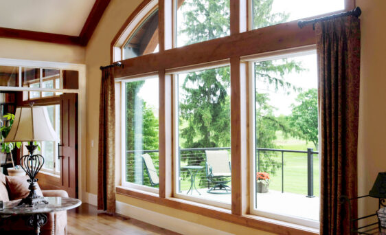Inside view of large windows, combination of arch windows and picture windows; example of Aeris windows in article about wood vs vinyl windows