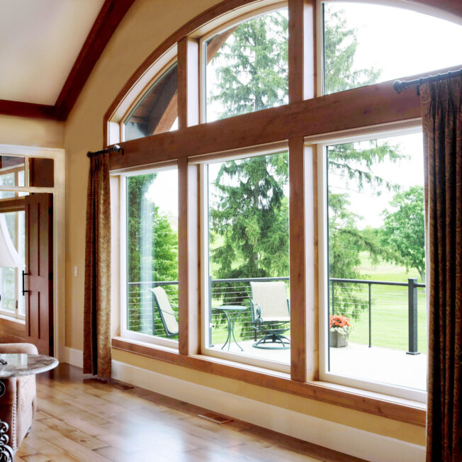 {Inside view of large windows, combination of arch windows and picture windows; example of Aeris windows in article about wood vs vinyl windows}