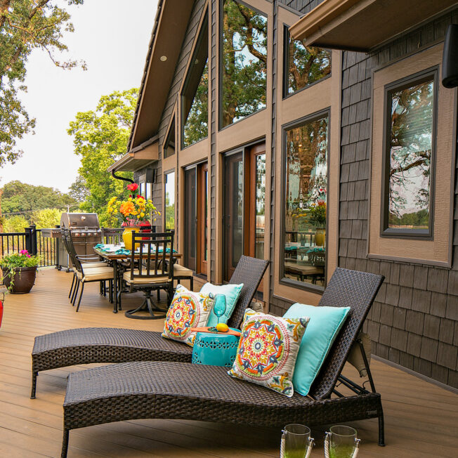 {Shaped and picture windows in Rustic Bronze on the deck area of an A-frame house}