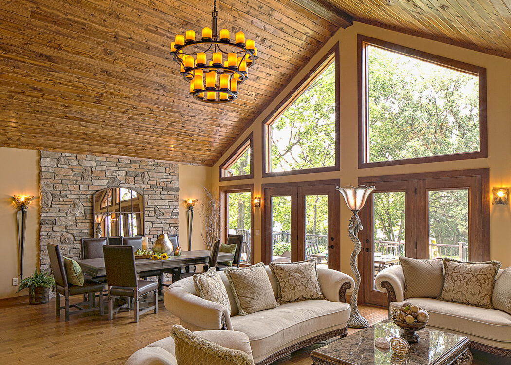 {Trapezoid shaped wood clad architectural windows inside a rustic living room; example of shaped windows in ProVia's window gallery}