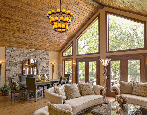 {Trapezoid shaped wood clad architectural windows inside a rustic living room; example of shaped windows in ProVia's window gallery}