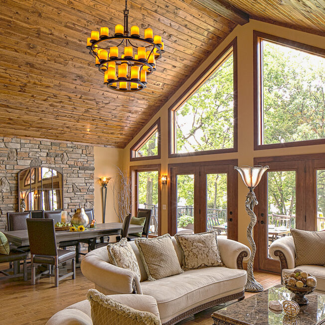 {Trapezoid shaped wood clad architectural windows inside a rustic living room; example of shaped windows in ProVia's window gallery}