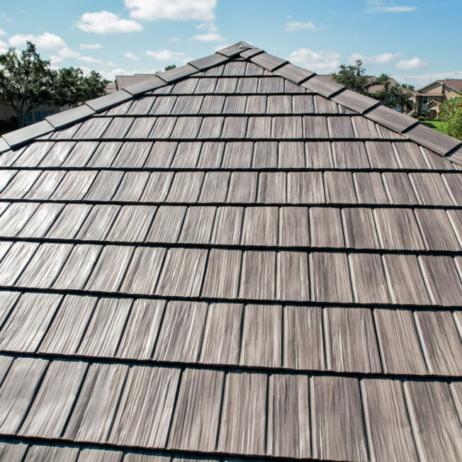 {Closeup aerial view of ProVia Briarwood Shake Metal Roofing on a home}