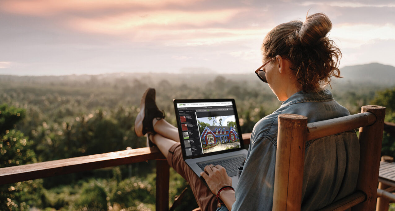 {Woman on a laptop outside using ProVia's Design Center home exterior design tools to design home exterior solutions.}