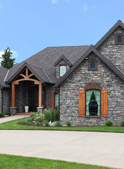 Exterior view of a home featuring ProVia's Terra Cut manufactured stone veneer in the color Slate in ProVia's stone gallery