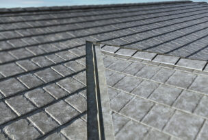 {Closeup of a roof with ProVia metal roofing in gray Ironstone Slate}