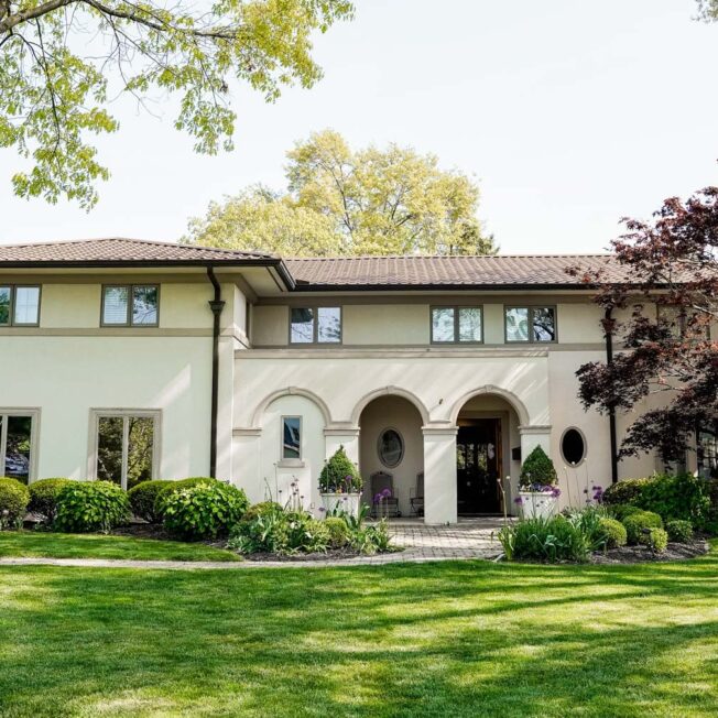 {Spanish-style home with a nice front yard and ProVia barrel tile metal roofing}