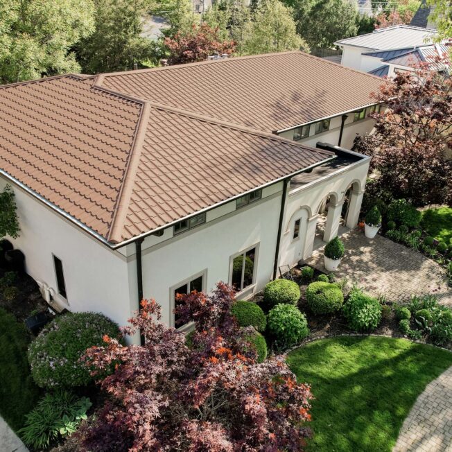 {Barrel tile metal roofing in Terracotta on a Spanish-style home}
