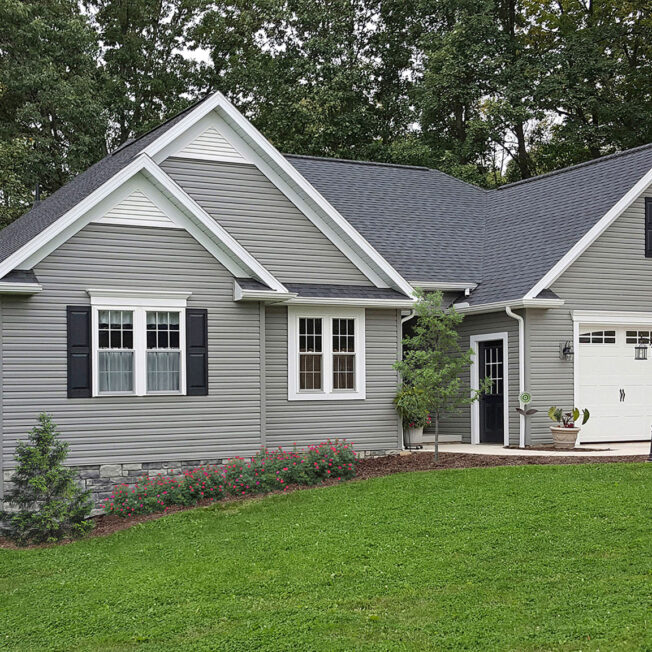 {Cedar Peaks wood grain vinyl siding in the color Pewter}