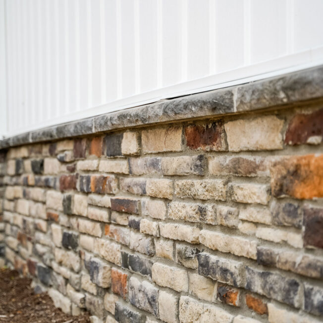 {Chisel Cut™ Brindle Manufactured Stone knee wall on a home exterior}