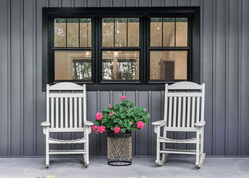 {Endure black double hung windows against dark gray board and batten}
