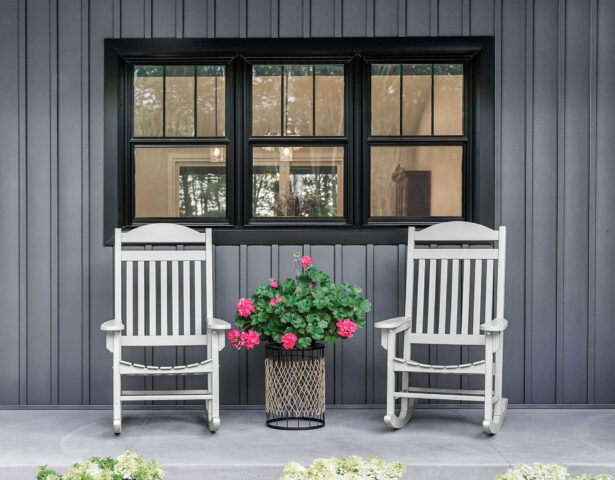 Endure black double hung windows against dark gray board and batten