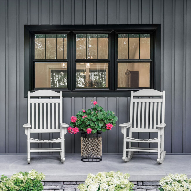 {Endure black double hung windows against dark gray board and batten}