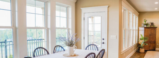 {Endure white double hung windows with cottage grids in a dining room}