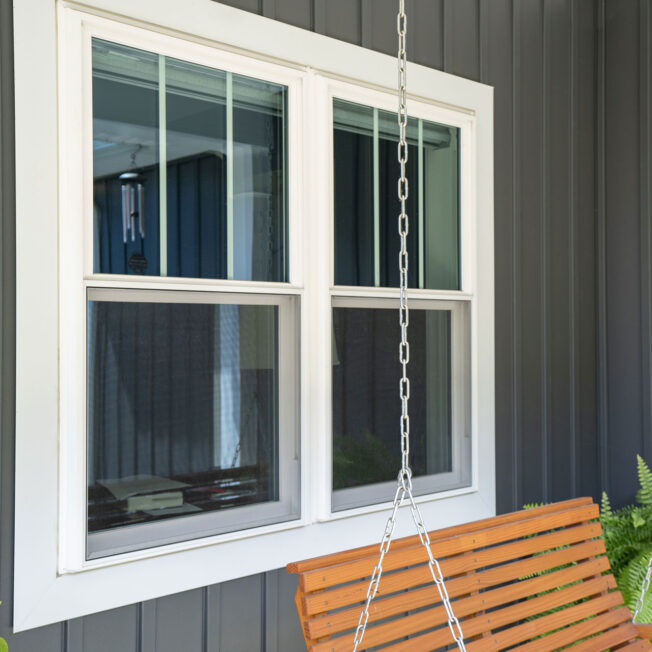 {Outside view of white Endure double hung windows with two vertical grids on the top halves only}