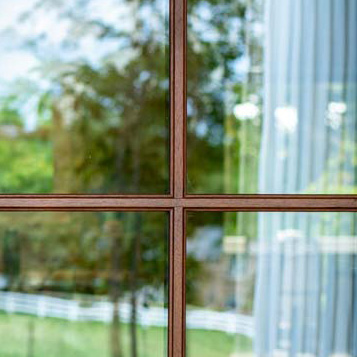 Closeup view of a ProVia Signet 440-2P entry door in Pecan with Simulated Divided Lites and clear glass