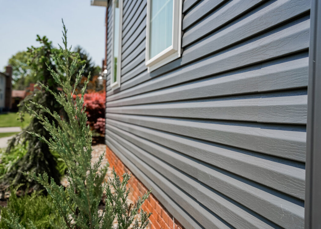 {HeartTech® Vinyl Siding in Sea Slate on the side of a home}