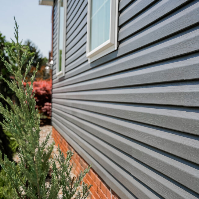{HeartTech® Vinyl Siding in Sea Slate on the side of a home}