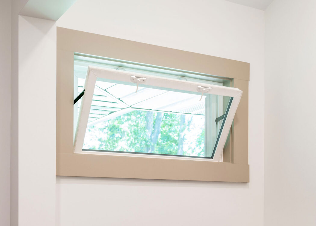 An opened Sandstone colored hopper window in a laundry room