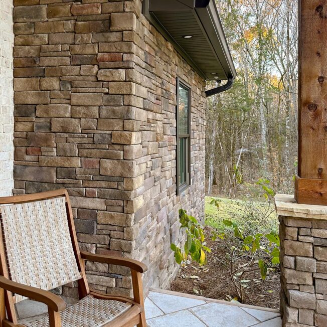 {Front porch view of Shawnee Dry Stack manufactured stone veneer on the outside of a home}