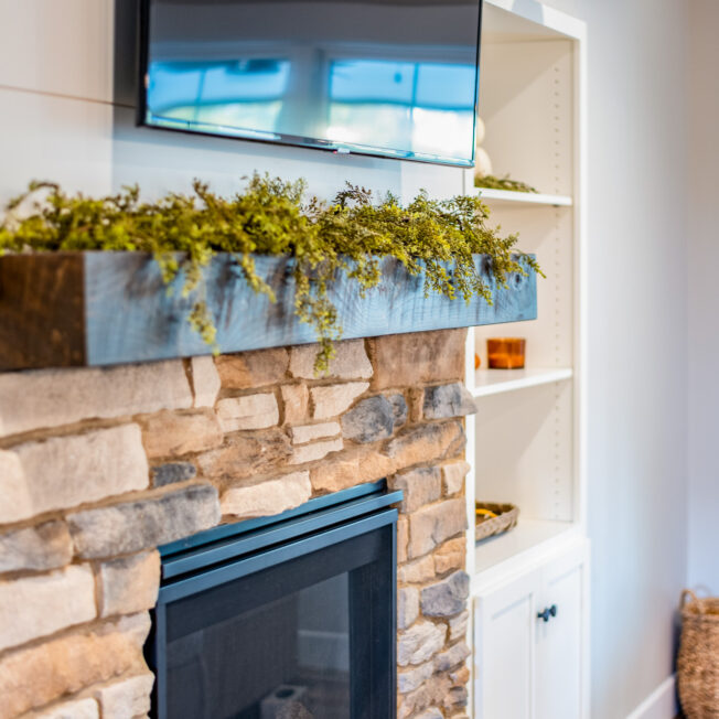 {Inside image of a stone fireplace featuring ProVia's Ledgestone profile in Brighton, example of stone fireplaces, Ledgestone stone veneer for fireplaces}