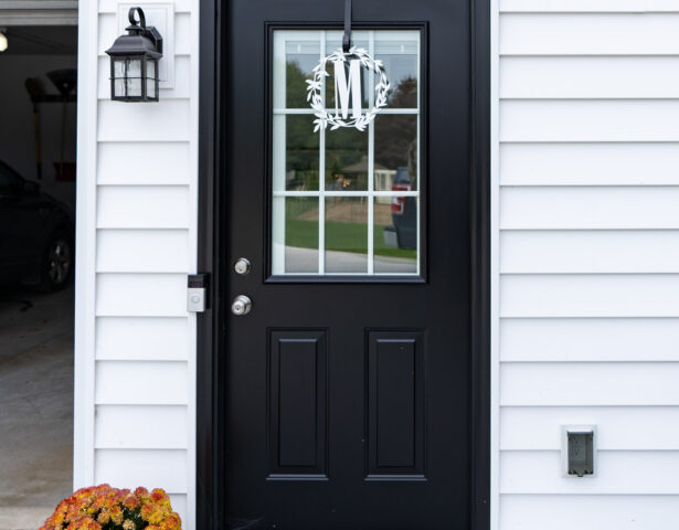 Legacy™ Steel Coal Black painted door with white internal grids on a garage entry, but excellent idea for front doors painted black