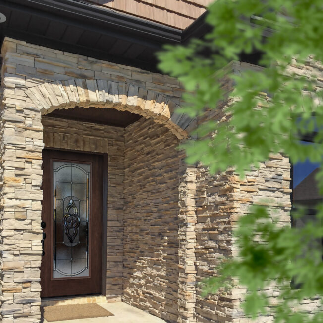 {PrecisionFit stack stone veneer in Adobe Sands on a home's exterior}