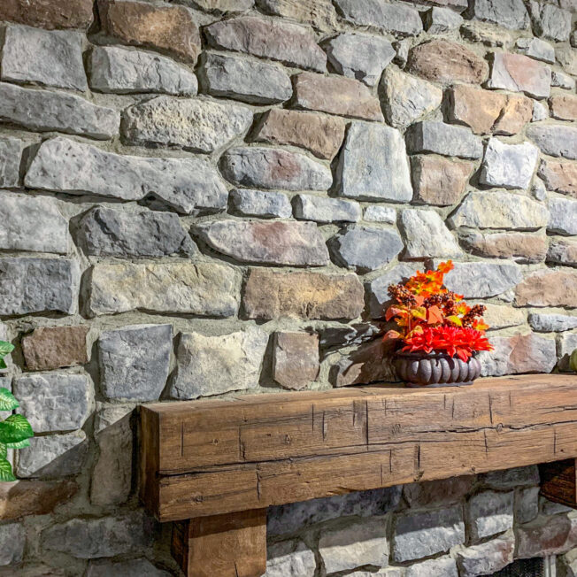 {Inside image of a stone fireplace featuring ProVia's Ridge Cut profile in Castle Rock, example of stone fireplaces, Ridge Cut stone veneer for fireplaces}