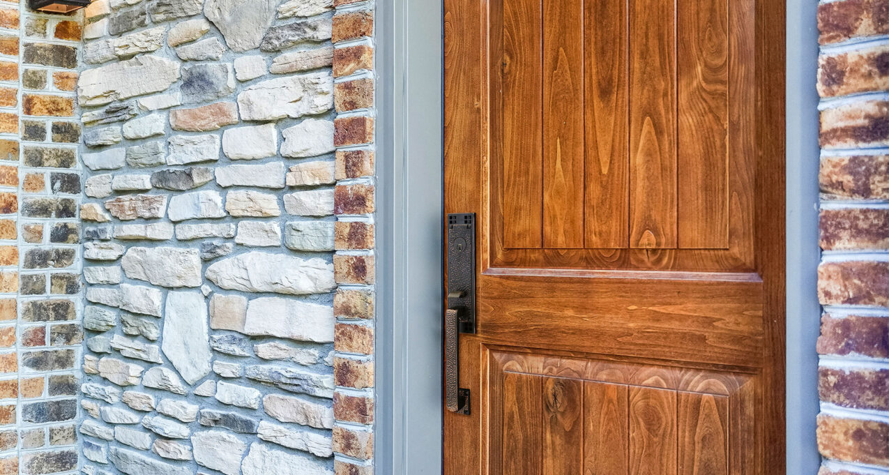 {Closeup of a Signet® 002CP 449 entry door in Caramel stain with a painted entry door frame}