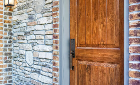 {Closeup of a Signet® 002CP 449 entry door in Caramel stain with a painted entry door frame}