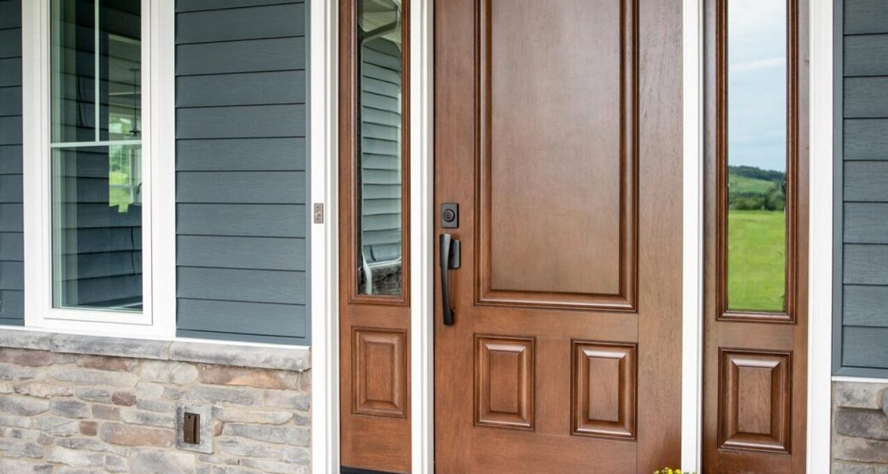 {Signet fiberglass door in mahogany skin, example of colors of front doors featuring medium brown Hazelnut stain; front doors with sidelites and transom}
