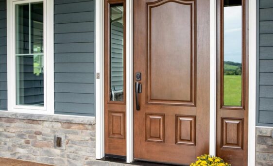 {Signet fiberglass door in mahogany skin, example of colors of front doors featuring medium brown Hazelnut stain; front doors with sidelites and transom}
