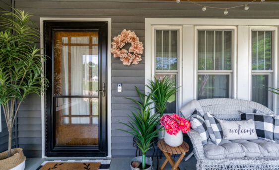 {One of ProVia’s Spectrum full view retractable screen storm doors in Coal Black, example of glass screen doors over an entry door, example of ProVia's exterior replacement doors options}