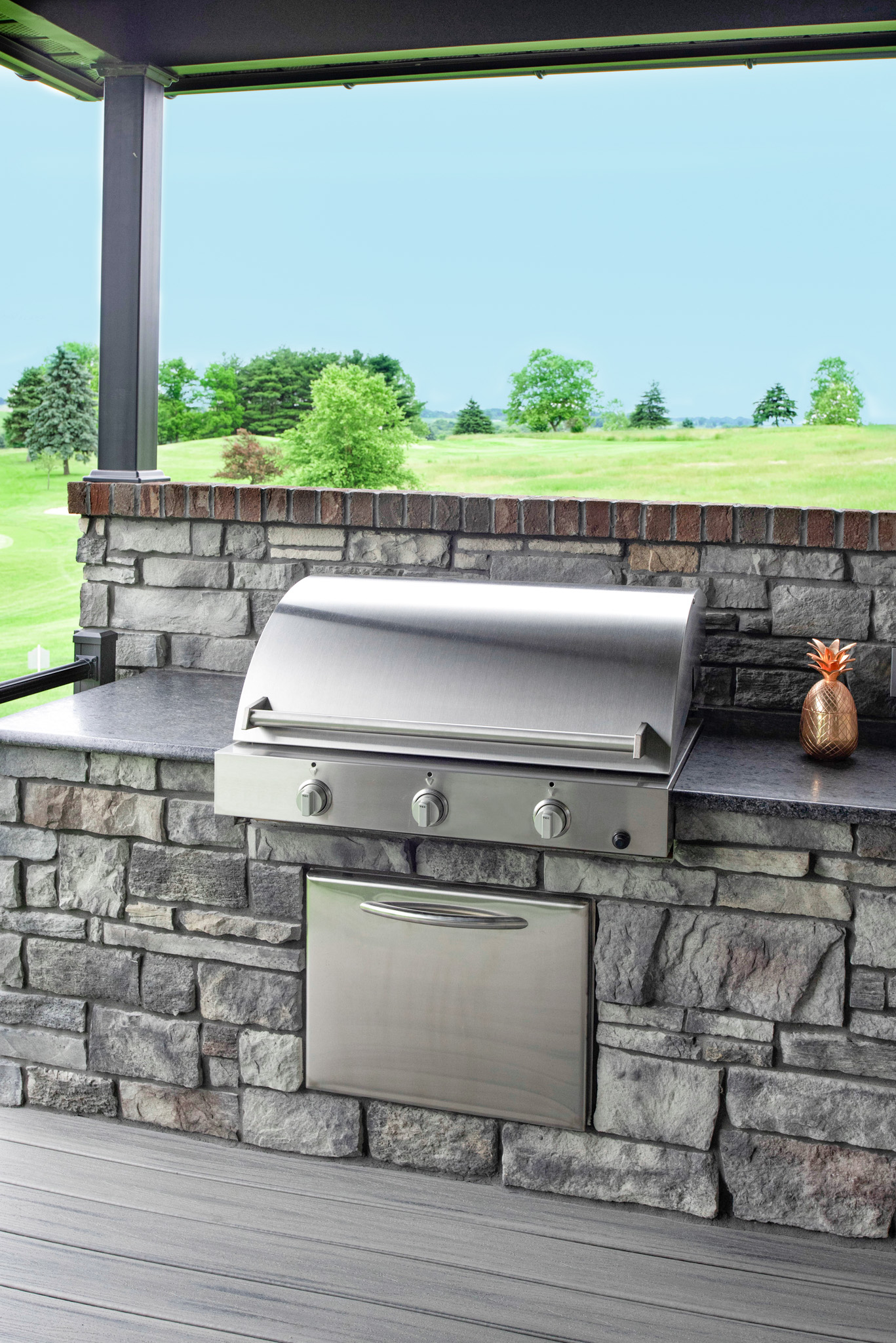 Outdoor kitchen grill area featuring ProVia's Terra Cut manufactured stone in the color Slate in ProVia's stone gallery