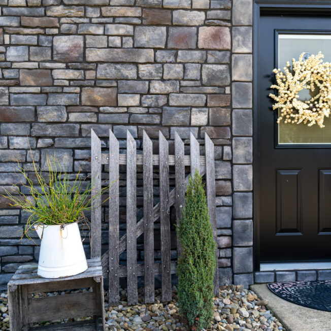{Home exterior featuring ProVia Terra Cut manufactured stone veneer, example of ProVia stone on a home exterior}