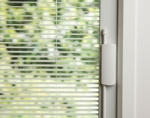 Closeup image of white internal blinds in an entry door