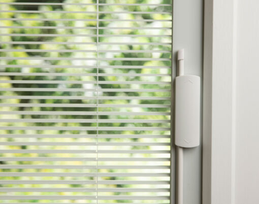 {Closeup image of white internal blinds in an entry door}