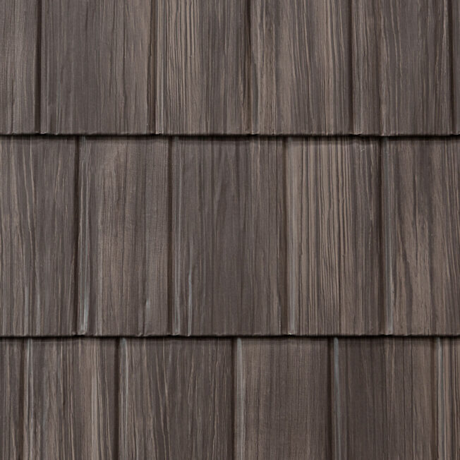 {Closeup image showing the details of ProVia's Briarwood brown colored shake metal shingle roof, example of metal roofing that looks like shake}