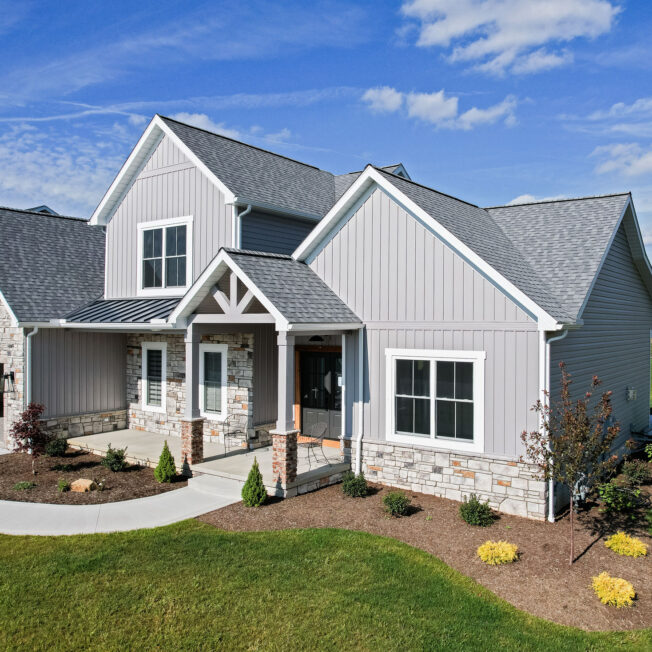 {Pewter HeartTech siding with Cedar Peaks board and batten on a newly constructed craftsman-style home}