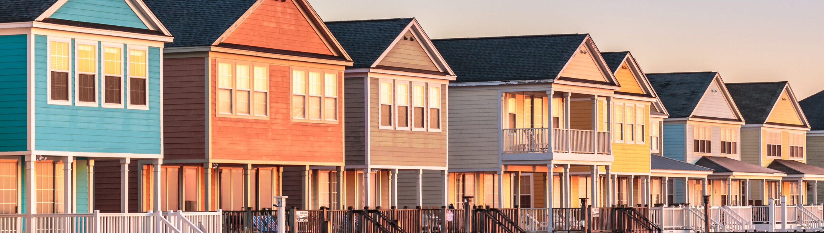 {A row of colorful beach houses to illustrate coastal warranty}