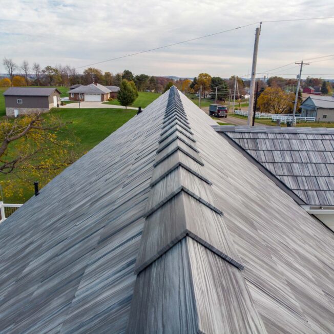 {View of the top of ProVia metal roofing in gray Pepperwood Shake}