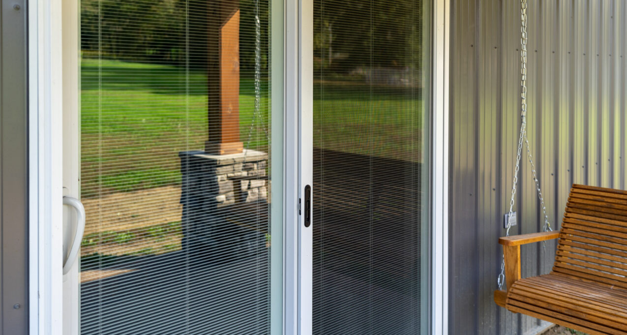 {Closeup outside view of ProVia's Endure vinyl patio door, example of blinds in sliding glass doors}