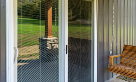 {Closeup outside view of ProVia's Endure vinyl patio door, example of blinds in sliding glass doors}