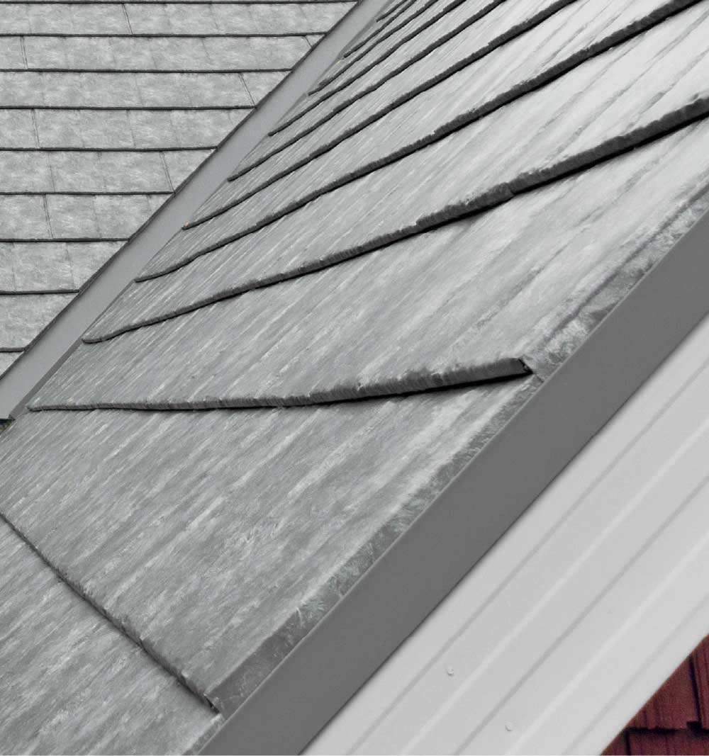 Closeup of a roof on a home showing ProVia's Ironstone Slate metal roofing with Pepper Iron Solid Trim