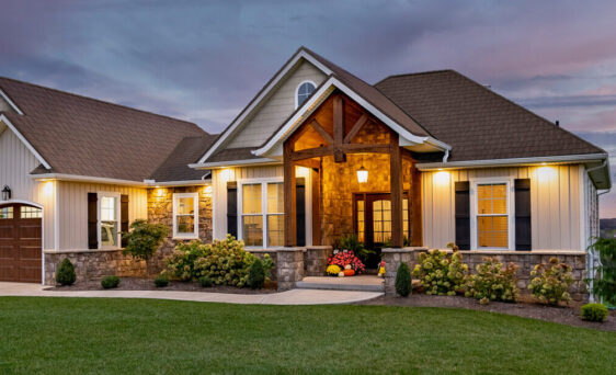 {Exterior view of a home with ProVia doors, windows, vinyl siding, manufactured stone, and metal roofing, demonstrating ProVia's home exterior solutions}