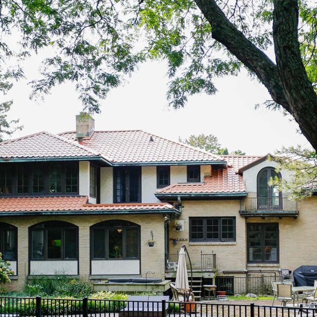 {Mediterranean or Spanish-style home with ProVia barrel tile metal roofing in Terracotta}