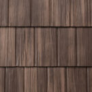 {Closeup image showing the details of ProVia's Saddlewood brown colored shake metal shingle roof, example of metal roofing that looks like shake}