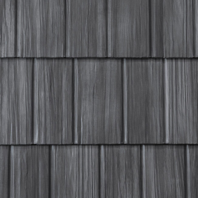 {Closeup image showing the details of ProVia's Shadewood gray colored shake metal shingle roof}
