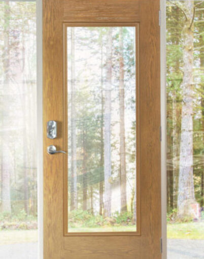 {A ProVia Signet® Oak Door with Clear Glass Sidelites looking out at a view of trees outside}