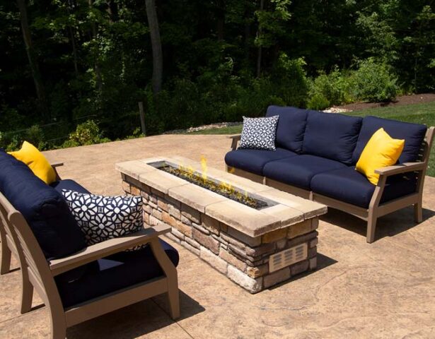 {Stone fire pits and stone fire tables such as this one with two cozy outdoor sofas can be a great addition to outdoor spaces}